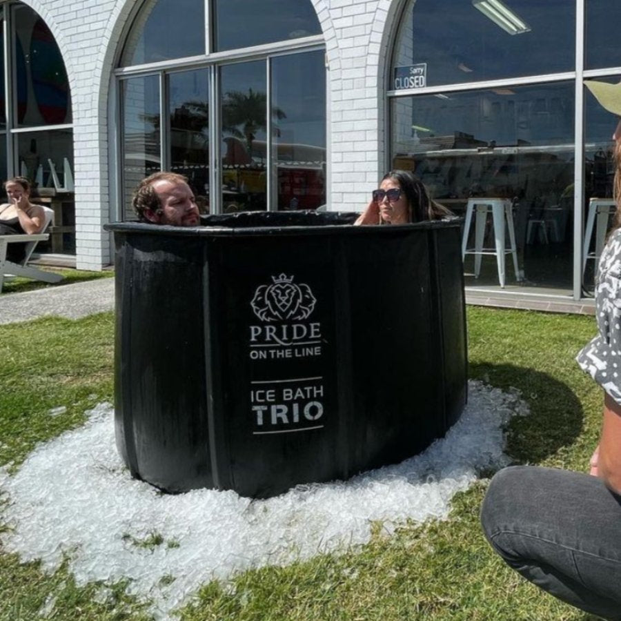 pride on the line portable recovery trio ice bath two people in the bath on the grass